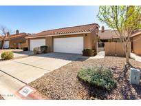 Charming home featuring a red tile roof, a two-car garage, and low-maintenance desert landscaping at 3510 E Hampton Ave # 126, Mesa, AZ 85204