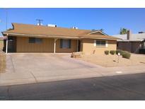 Tan single-story home with a covered parking area and desert landscaping in the front yard at 3520 N 85Th St, Scottsdale, AZ 85251