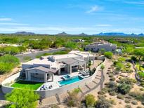 Scenic aerial view of a desert home with a pool, patio, and landscaped backyard at 35348 N 87Th St, Scottsdale, AZ 85266