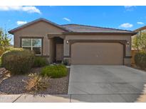 Charming single-story home with a well-maintained yard and a two-car garage and a neutral color stucco at 393 S Soledad Ln, Casa Grande, AZ 85194