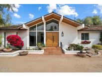 Inviting front entrance with modern double doors, ample natural light, and desert landscaping at 4010 E Montebello Ave, Phoenix, AZ 85018