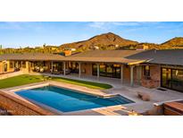 Private backyard oasis with a refreshing pool and manicured lawn space at 5480 E Desert Creek Ln, Cave Creek, AZ 85331