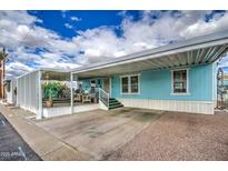 A charming single-story home showcasing a covered carport and pleasant exterior paint at 7807 E Main St # H12, Mesa, AZ 85207