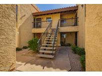 Charming condo complex featuring desert landscaping, walkways, and stairs leading to upper-level units at 8201 N 21St Dr # C204, Phoenix, AZ 85021