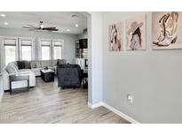 Inviting living room featuring a large sectional, ceiling fan, and stylish decor at 12204 W Black Hawk Rd, Casa Grande, AZ 85194
