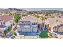 Stunning two-story home showcasing a manicured lawn and three-car garage nestled in a picturesque neighborhood at 13236 N 13Th St, Phoenix, AZ 85022