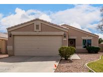 Inviting single-story home featuring a well-maintained front yard with a two car garage at 1753 E Pinto Dr, Gilbert, AZ 85296