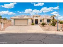 Charming single-story home featuring a two-car garage, desert landscaping, and a new solar panel system at 23219 N 145Th Dr, Sun City West, AZ 85375