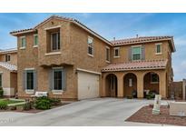 Inviting two-story home featuring a covered entry, attached garage and manicured landscaping at 26868 N 104Th Ln, Peoria, AZ 85383