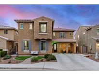 Charming two-story home with a neutral stucco exterior, decorative shutters, and a well-manicured front yard at 26868 N 104Th Ln, Peoria, AZ 85383