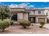 Charming two-story home with well-maintained desert landscaping and a tile roof at 36076 N Vidlak Dr, San Tan Valley, AZ 85143