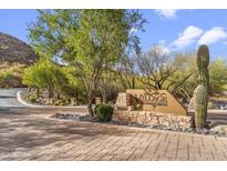 Inviting entrance to The Village at Surrey Hills with lush landscaping and desert scenery at 36600 N Cave Creek Rd # D11, Cave Creek, AZ 85331