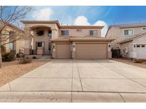 Beautiful two-story home with a three car garage and neutral stucco exterior at 45105 W Horse Mesa Rd, Maricopa, AZ 85139