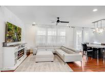 Bright living room showcasing a plush sectional, fireplace, and hardwood floors at 4705 E Betty Elyse Ln, Phoenix, AZ 85032