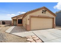 Charming single-story home with a two-car garage and low maintenance landscaping at 61 S 111Th Pl, Mesa, AZ 85208