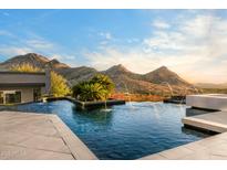 Stunning infinity pool with mountain views and water features, perfect for relaxing and entertaining at 10324 E Calle De Las Brisas --, Scottsdale, AZ 85255