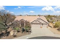 Charming home with desert landscaping, three car garage, and a beautiful tile roof at 11152 E White Feather Ln, Scottsdale, AZ 85262