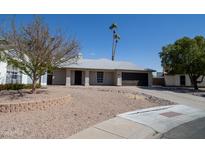 Charming single-story home with desert landscaping and a two-car garage on a sunny day at 16409 S 46Th St, Phoenix, AZ 85048