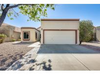 Charming single-story home featuring a two-car garage and desert landscaping at 1713 E Morelos St, Chandler, AZ 85225