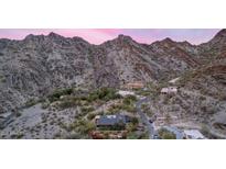 Panoramic aerial view of a hillside home with desert landscaping and mountain views at dusk at 1844 E Cinnabar Ave, Phoenix, AZ 85020