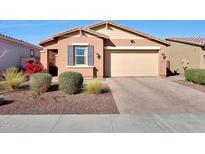 Charming single-story home with a well-manicured front yard and attached two-car garage at 19990 W Turney Ave, Litchfield Park, AZ 85340