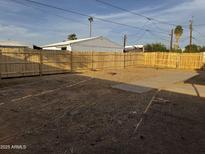 Expansive backyard featuring a new wooden fence, offering privacy and ample space for outdoor activities at 2034 E Charleston Ave, Phoenix, AZ 85022