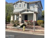 Charming two-story home with stone accents, a covered porch, and well-maintained landscaping at 21134 W Green St, Buckeye, AZ 85396