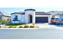 Charming single-story home featuring a turret entrance and a well-manicured front yard with unique decor at 22891 E Via Del Sol --, Queen Creek, AZ 85142