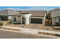 Charming single-story home featuring a tile roof, brick driveway, and inviting arched entryway at 22891 E Via Del Sol --, Queen Creek, AZ 85142