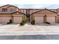 Exterior view of the townhome with attached garages and landscaped front yards at 250 W Queen Creek Rd # 240, Chandler, AZ 85248