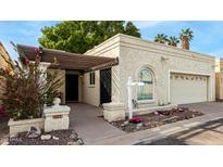 Charming single-story home featuring a stucco facade, mature trees, and a welcoming front porch at 2824 N 42Nd Way, Phoenix, AZ 85008