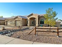 Charming single-story home boasts a desert landscape, three-car garage, and welcoming entrance at 2922 E Encanto St, Mesa, AZ 85213