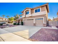 Two-story home featuring a three-car garage and low-maintenance desert landscaping at 2977 E Teakwood Pl, Chandler, AZ 85249