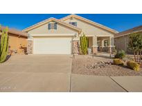 Inviting home with neutral stucco, river rock accents, desert landscaping and a 2 car garage at 30153 N Gecko Trl, San Tan Valley, AZ 85143