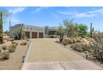 Stunning Southwestern home with a spacious driveway and three-car garage, surrounded by desert landscaping at 30600 N Pima Rd # 24, Scottsdale, AZ 85266