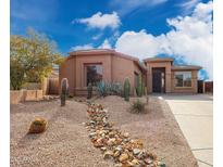 Charming single-story home with desert landscaping, a wide driveway and a two car garage at 34705 N 26Th Ave, Phoenix, AZ 85086