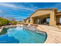 Stunning backyard showcasing a pool with spa, water feature, and patio, perfect for outdoor entertaining and relaxation at 37654 N 102Nd Pl, Scottsdale, AZ 85262