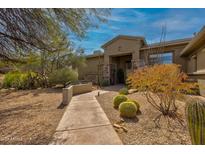 Beautiful desert landscaping and walkway leading up to the entrance of this charming home at 37654 N 102Nd Pl, Scottsdale, AZ 85262