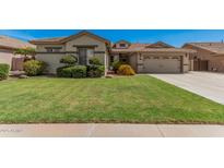 Charming home featuring a lush green lawn and manicured landscaping, creating a welcoming curb appeal at 4109 E Del Rio St, Gilbert, AZ 85295