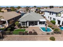 Aerial view of a home showcasing its outdoor amenities including pool, putting green and patio at 43851 W Griffis Dr, Maricopa, AZ 85138