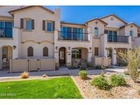 Inviting two-story townhome with landscaped front yard and cozy porch seating at 4655 S Glacier --, Mesa, AZ 85212