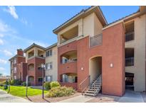 Condominium building exterior with walkway, stairs, and balconies on a sunny day at 5401 E Van Buren St # 1103, Phoenix, AZ 85008