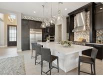 A gourmet kitchen with stainless steel appliances, a large island, and stylish pendant lighting at 5411 E Duane Ln, Cave Creek, AZ 85331