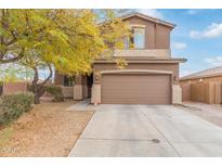 Two-story home featuring neutral stucco, a brown garage door, and a well-maintained front yard at 900 W Broadway Ave # 66, Apache Junction, AZ 85120