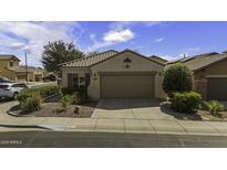 Charming single-story home featuring a two-car garage and manicured front yard at 9149 E Auburn St, Mesa, AZ 85207