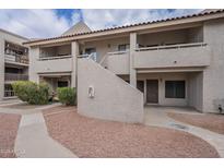 Multi-level apartment complex featuring red rock landscaping and a textured facade at 11666 N 28Th Dr # 196, Phoenix, AZ 85029