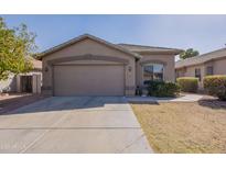 Charming home featuring a two-car garage, neutral tones, and a well-maintained front yard at 16167 W Cottonwood St, Surprise, AZ 85374