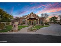 Beautiful brick home featuring manicured front lawn, stone accents, and covered entryway at 315 S Racine Ct, Gilbert, AZ 85296