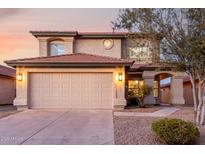Charming two-story home featuring a neutral exterior, a two-car garage, and manicured landscaping at 4720 E Adobe Dr, Phoenix, AZ 85050