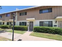 Charming townhome featuring a well-maintained front yard and classic architectural details at 5429 N Black Cyn Hwy, Phoenix, AZ 85015